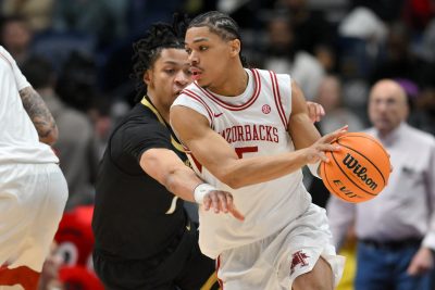 Darius Acuff Jr. dribbles the ball defended by Vanderbilt Commodores guard Chandler Bing.