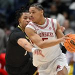 Darius Acuff dribbles the ball.