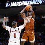 Tramon Mark of Texas shoots over an NC State defender.