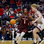 Texas A&M Aggies guard Josh Holloway (1) dribbles the ball during a first round game of the men's 2026 NCAA Tournament.