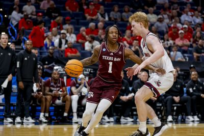 Texas A&M Aggies guard Josh Holloway (1) dribbles the ball during a first round game of the men's 2026 NCAA Tournament.