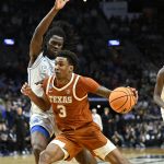 Dailyn Swain drives against BYU Cougars forward Khadim Mboup.