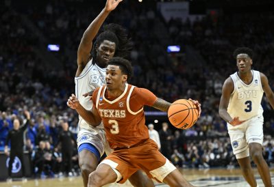 Dailyn Swain drives against BYU Cougars forward Khadim Mboup.