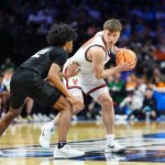 Virginia Cavaliers guard Dallin Hall looks to pass as Wright State Raiders guard TJ Burch defends.