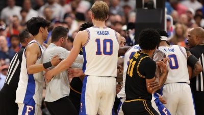 Florida and Iowa players scuffle.