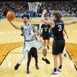 Duke Blue Devils guard Cayden Boozer shoots as Texas Christian University Horned Frogs guard Liutauras Lelevicius defends.