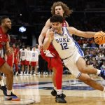 Duke Blue Devils forward Cameron Boozer dribbles the ball past St. John's Red Storm forward Ruben Prey.