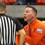 Auburn coach Steven Pearl talks to an official.