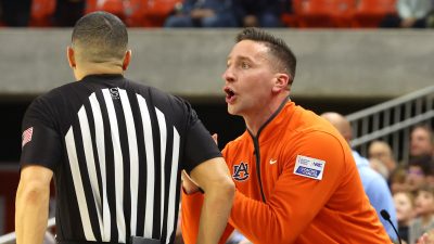 Auburn coach Steven Pearl talks to an official.
