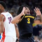 Michigan's Elliot Cadeau celebrates.