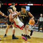 Michigan Wolverines guard Trey McKenney drives to the basket against Arizona Wildcats guard Anthony Dell'orso.