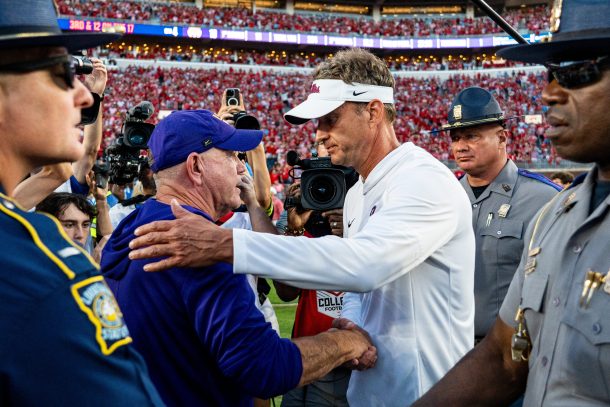 Brian Kelly and Lane Kiffin shake hands.