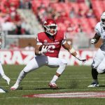 Arkansas and Tulsa play football.