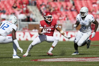 Arkansas and Tulsa play football.