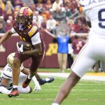 Javon Tracy runs with the ball.