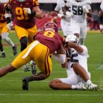 Oregon QB Dante Moore is knocked out by a late hit from USC.