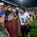 Kentucky QB Kenny Minchey celebrates with fans.