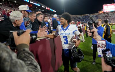 Kentucky QB Kenny Minchey celebrates with fans.