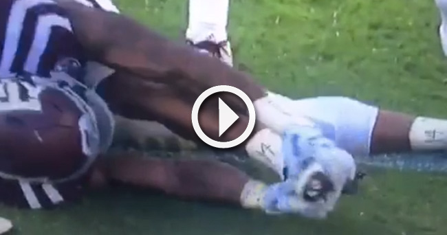 place texas player laying pops field knee football leg while own